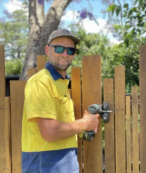 pic of Troy installing a lock to a gate